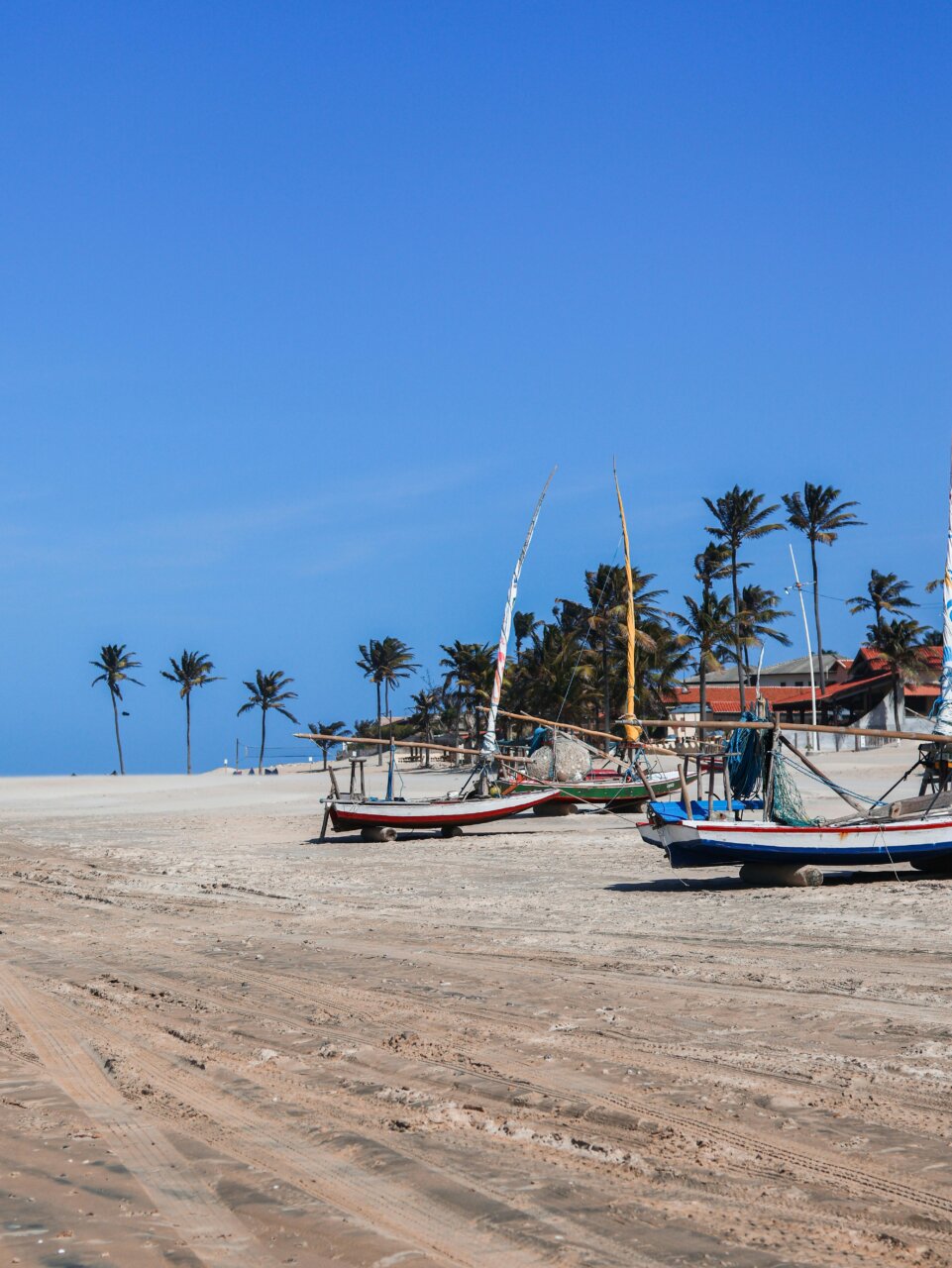 Playa en Ceará con botes de pesca y palmeras al fondo