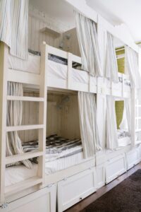 Camas en un albergue rehabilitado con cortinas y decoración moderna